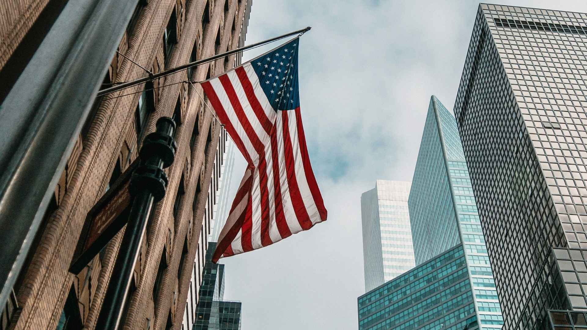 USMLE Prep with Dr. Heba American flag in a cityscape background — representing Dr. Heba's USMLE tutoring services for international medical students aiming to practice in the United States.